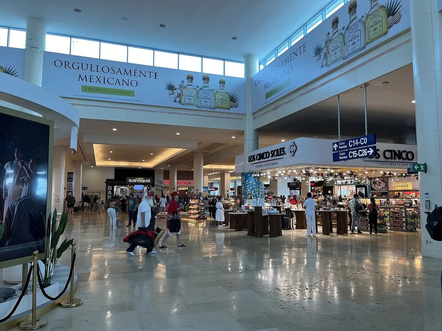 Concourse of a terminal at Cancun International Airport, with shops and passengers