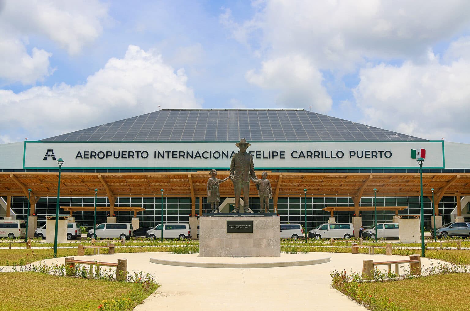 Facade of Felipe Carrillo Puerto International Airport in Tulum, with the monument to Felipe Carrillo Puerto in front