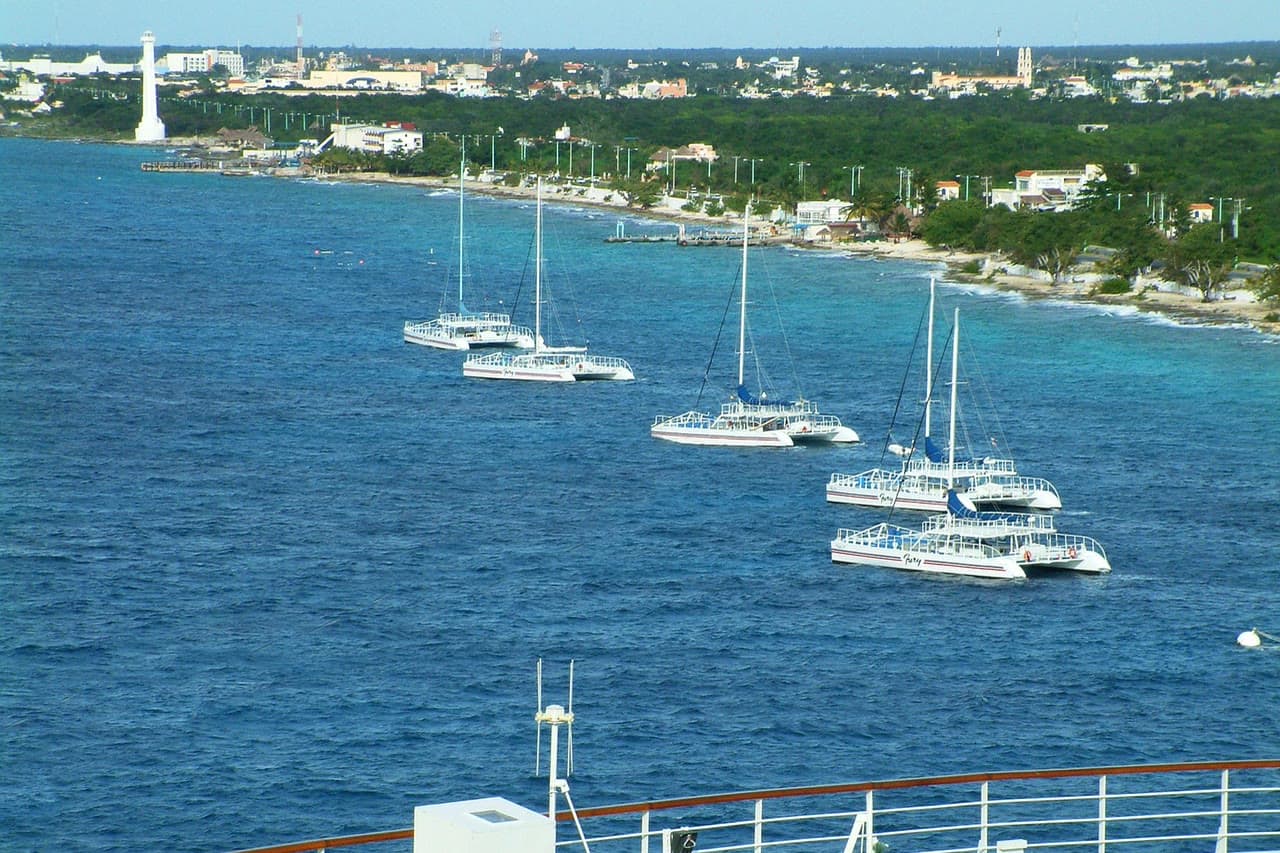 Cozumel's shore seen from the sea, with catamarans anchored off San Miguel