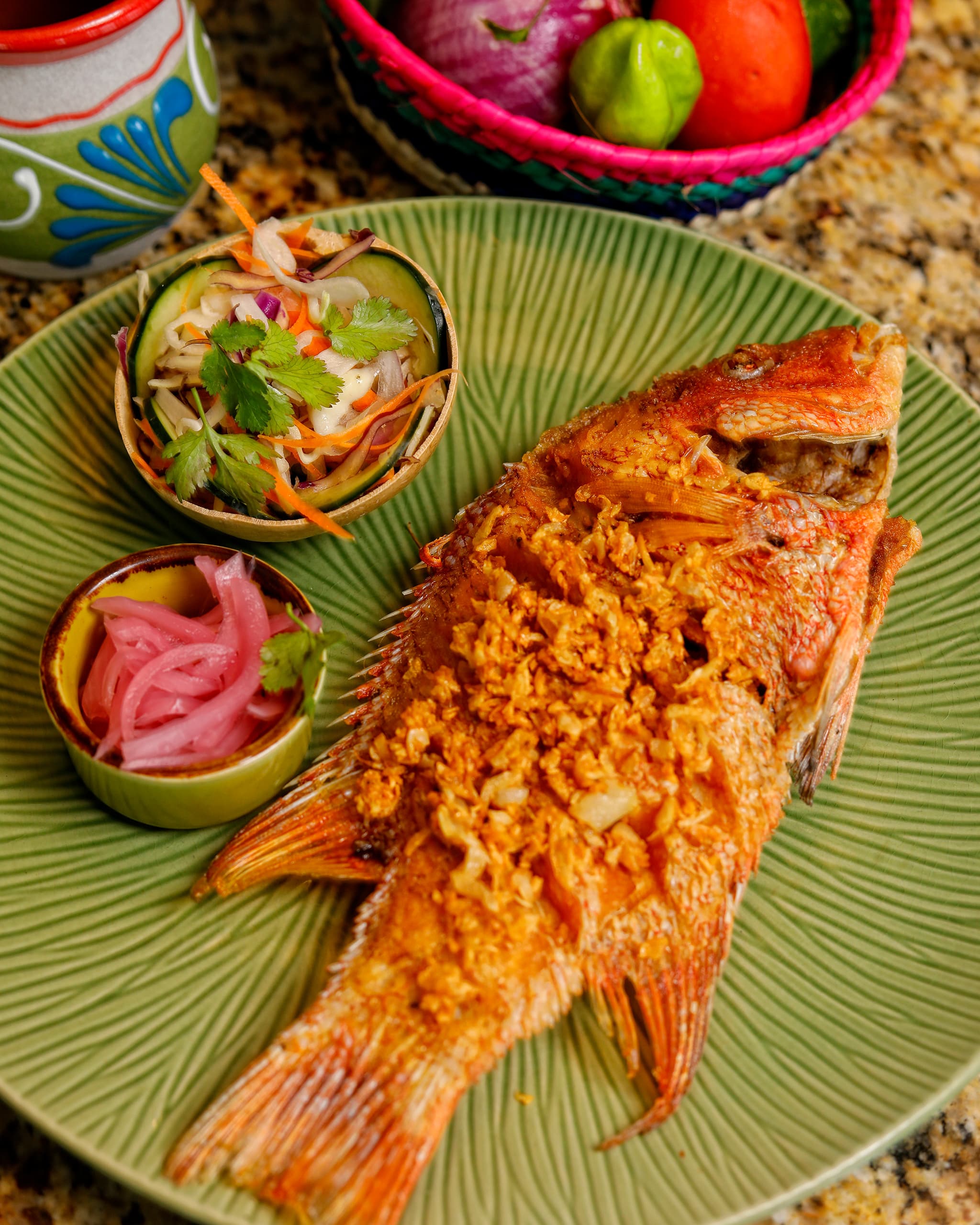 Whole fried fish with slaw and pickled red onion