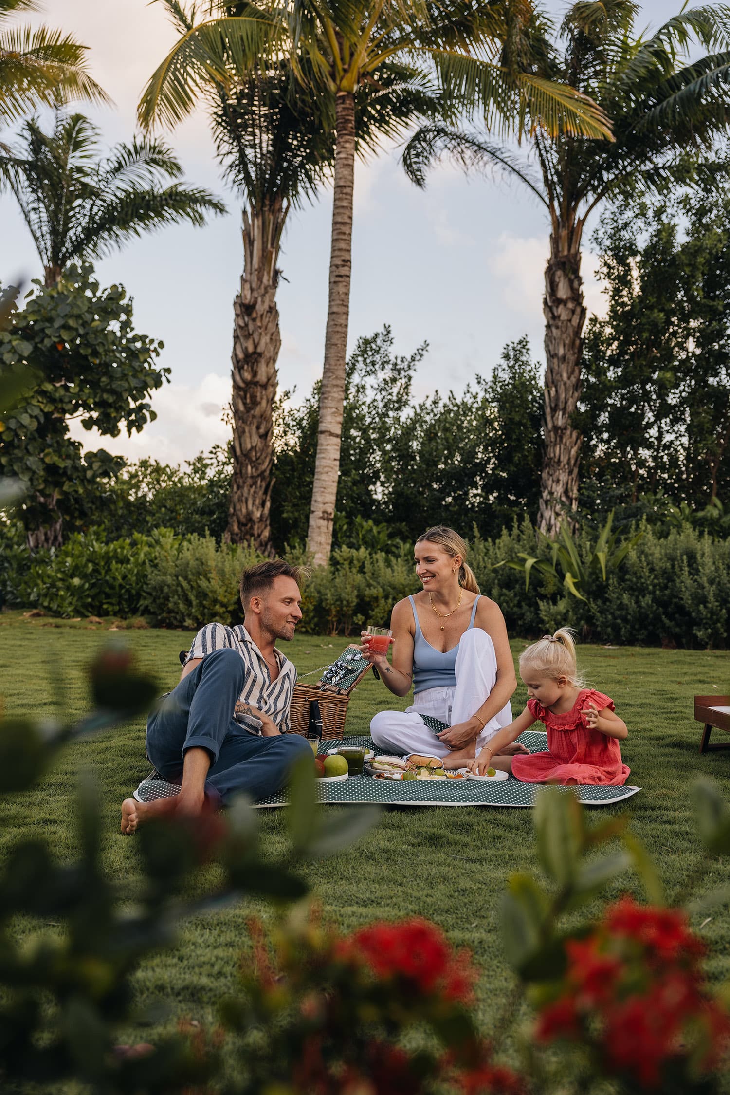Family picnicking in a tropical garden