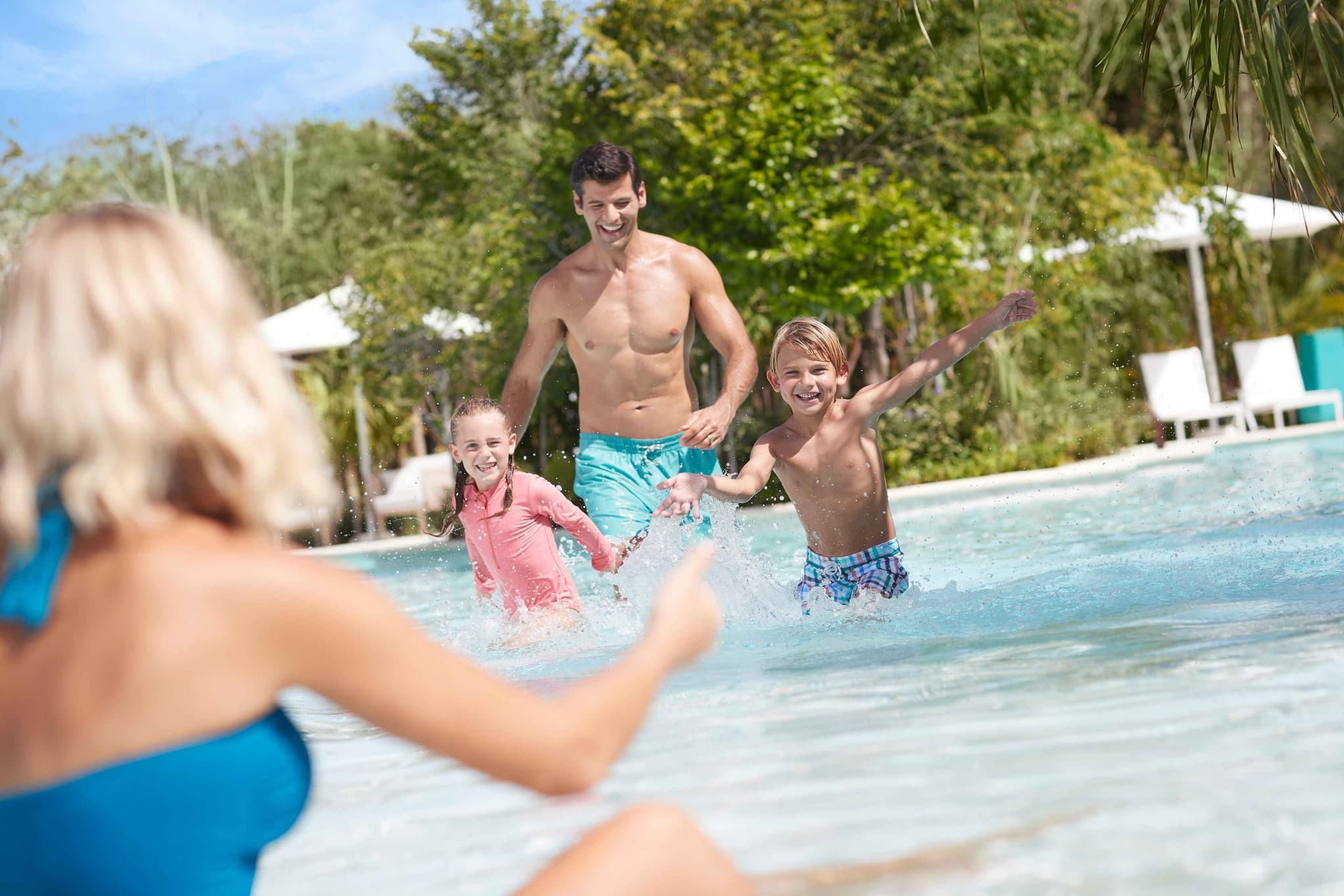 Family playing in the pool