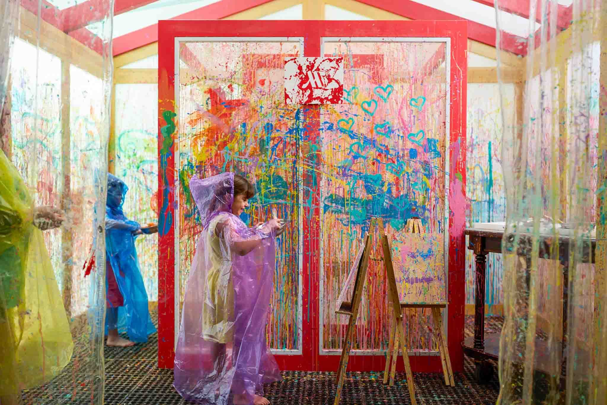 Children painting in an open-air workshop