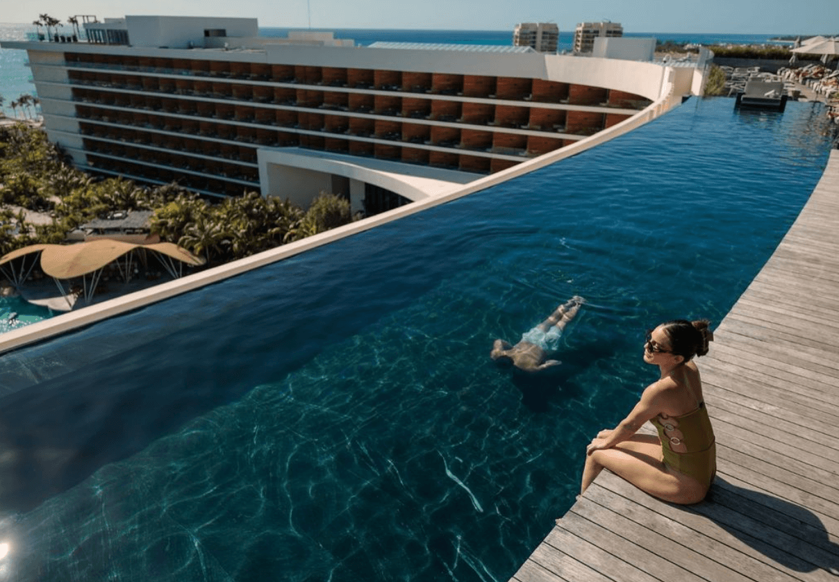 Infinity pool facing the sea with the resort behind