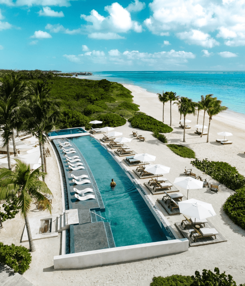 A long pool beside the beach and the turquoise sea