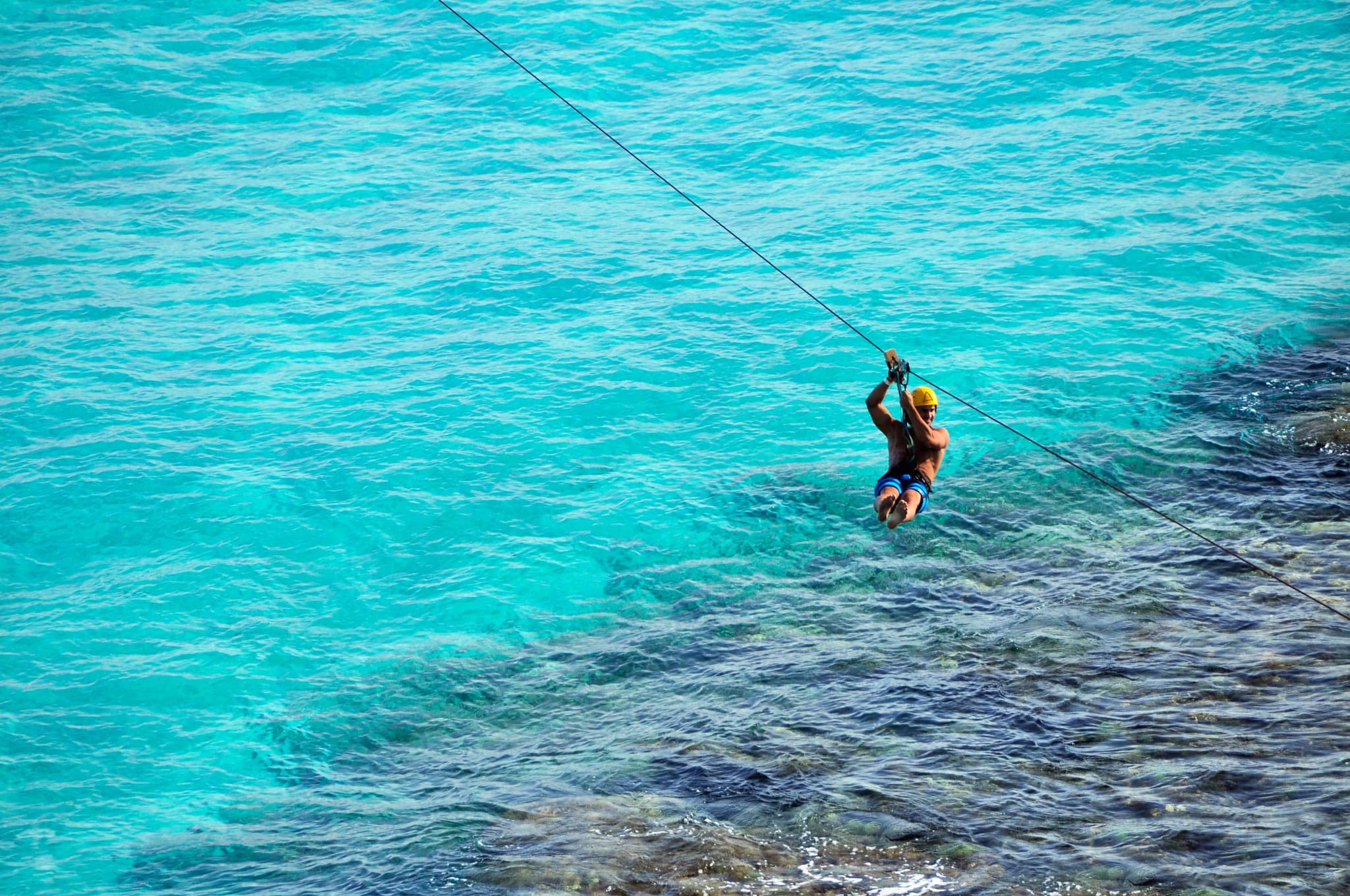 Zipline over the turquoise water at Garrafón, Isla Mujeres