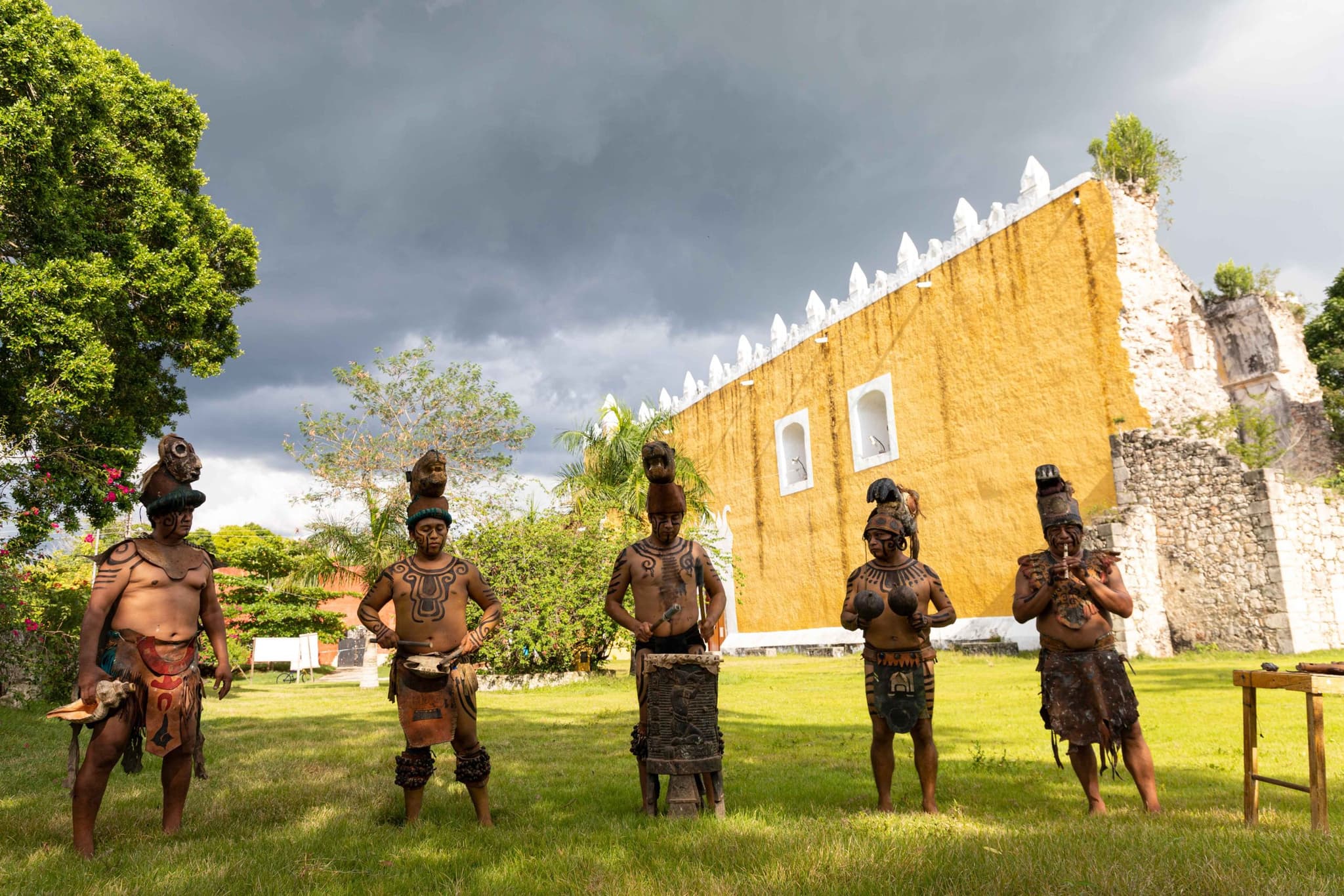 Maya guardians in front of a historic building in Maya Ka'an