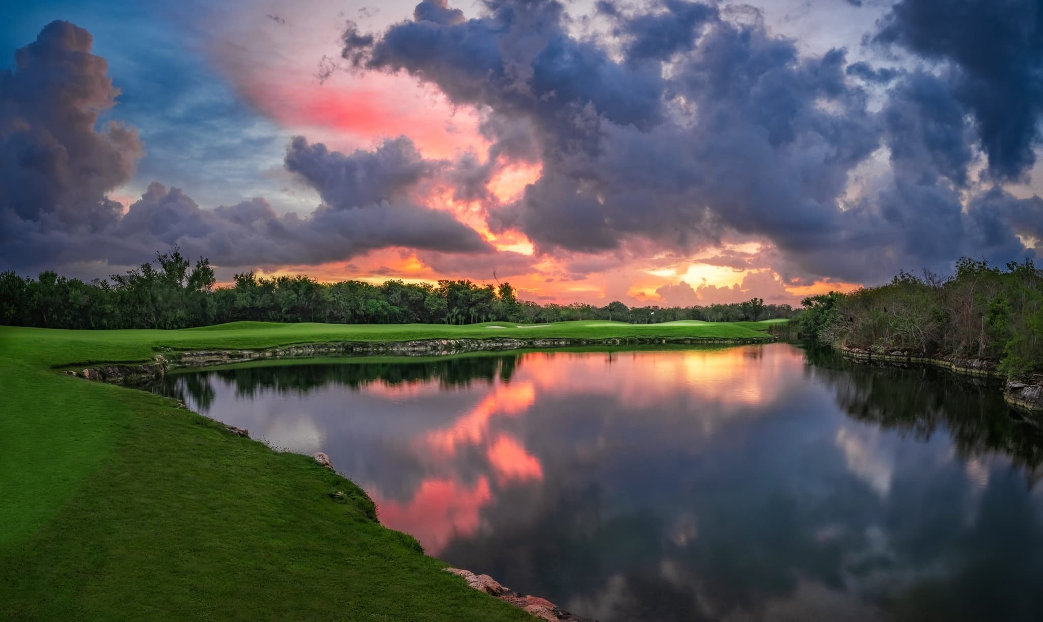 Golf course at dawn beside a lake