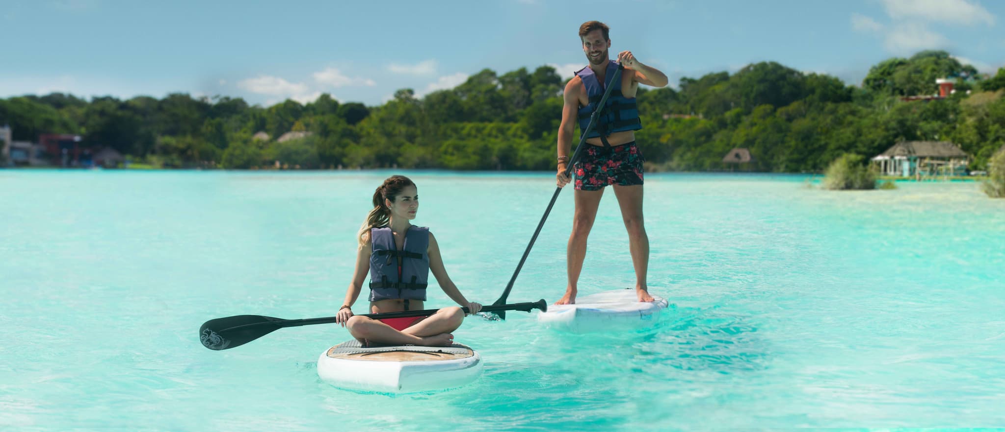 Couple paddleboarding on the Bacalar Lagoon